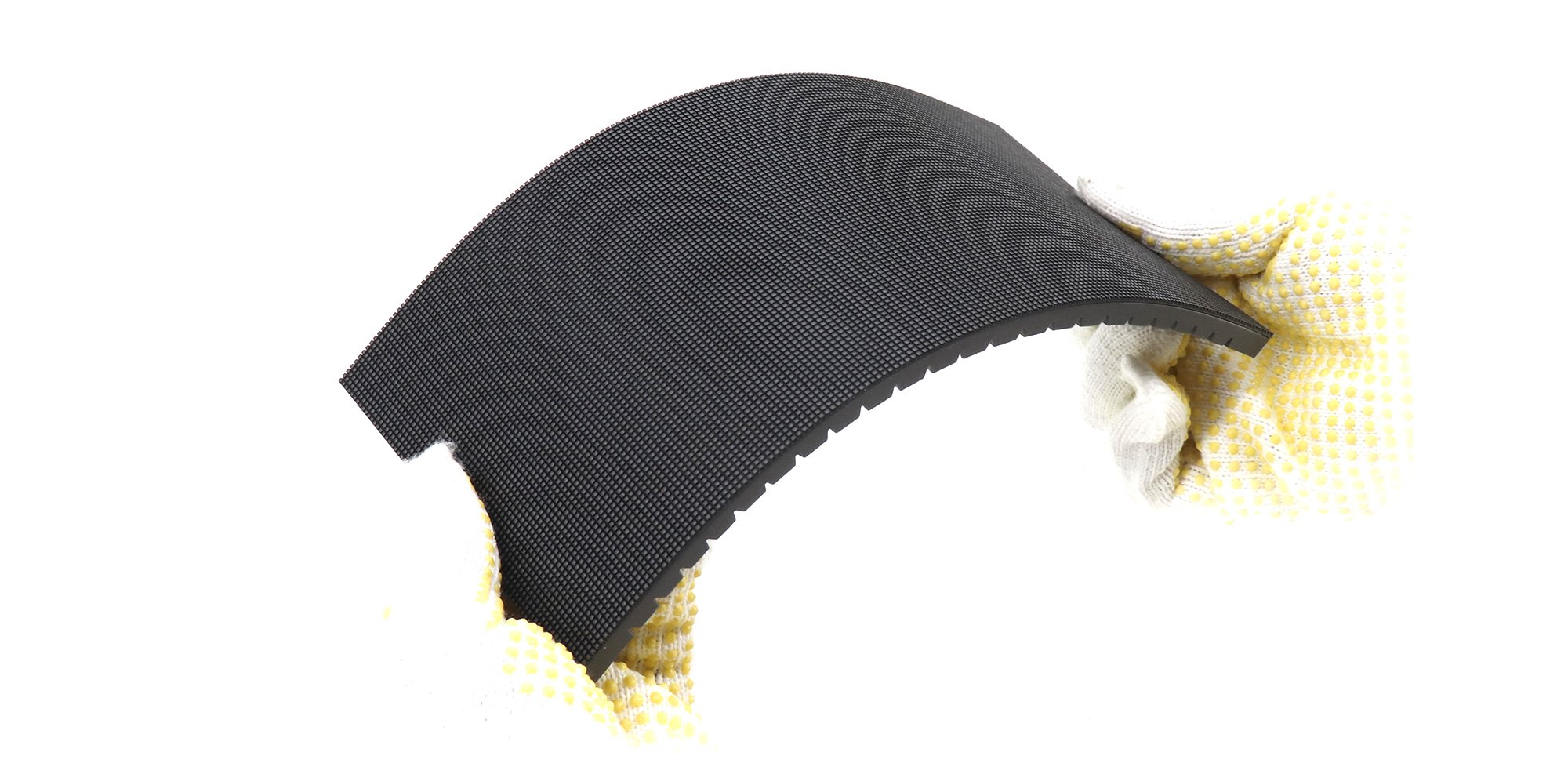 Flexible indoor LED module held in a curved shape with gloved hands